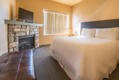 In-Room Fireplace and King Bed in Podollan Rez-idence Fort McMurray Suite