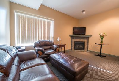 Podollan Rez-idence Fort McMurray Suite Living Area with Leather Couches & Fireplace